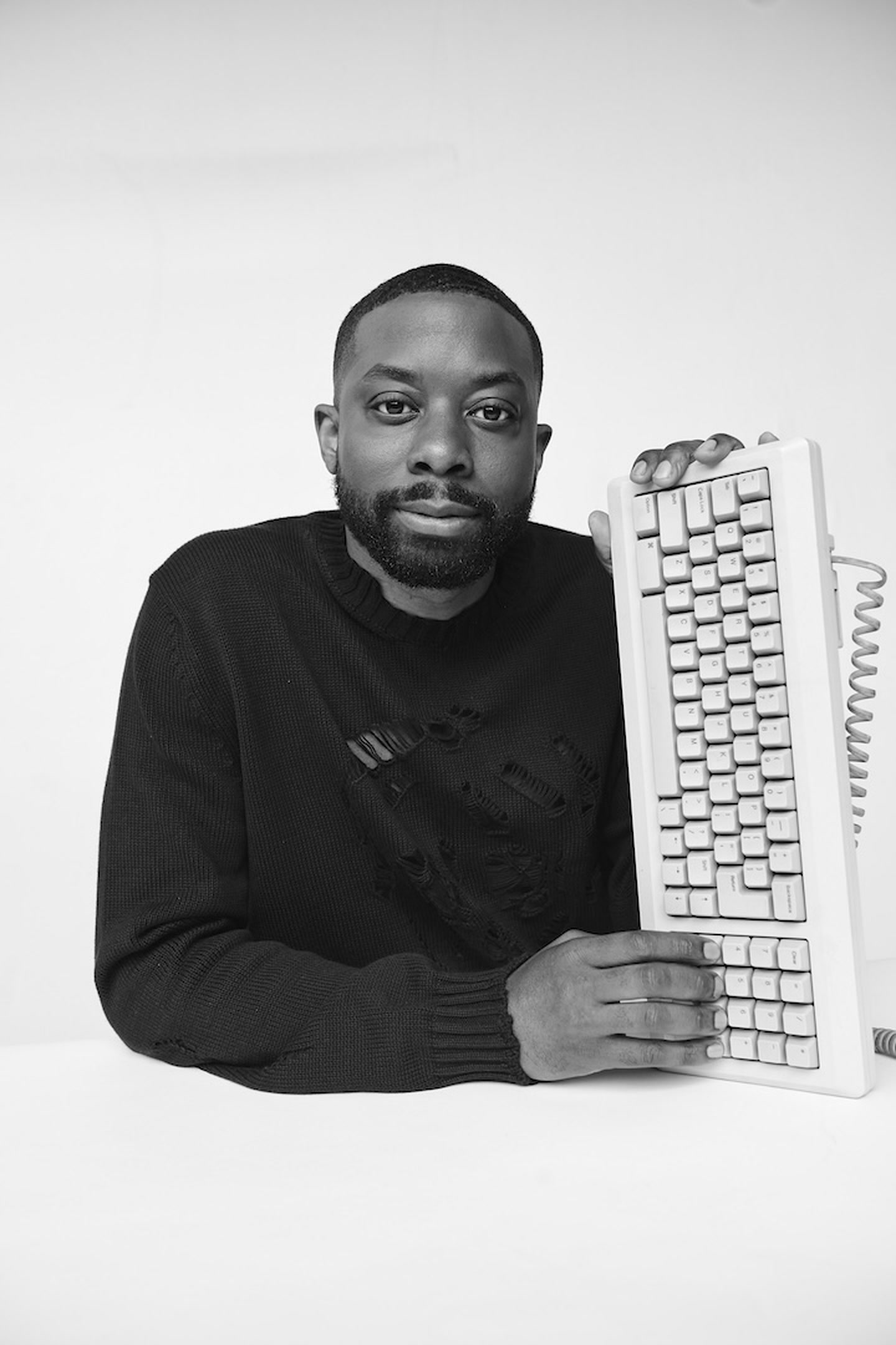 John Imah beside a vintage keyboard