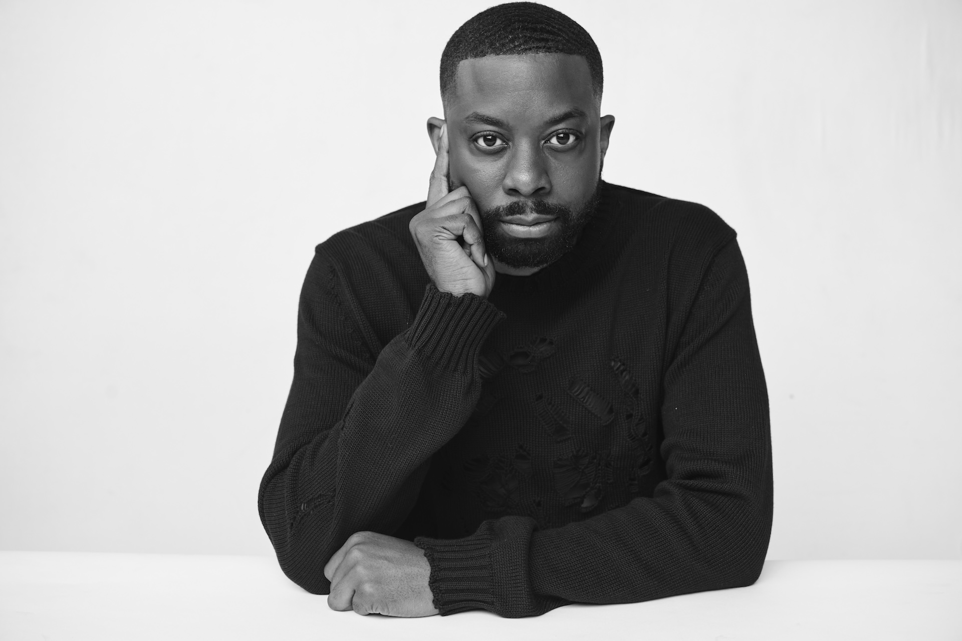 John Imah in a black-and-white studio portrait