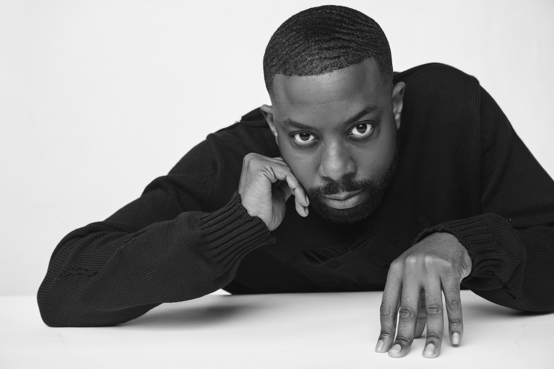 John Imah in a black-and-white editorial portrait